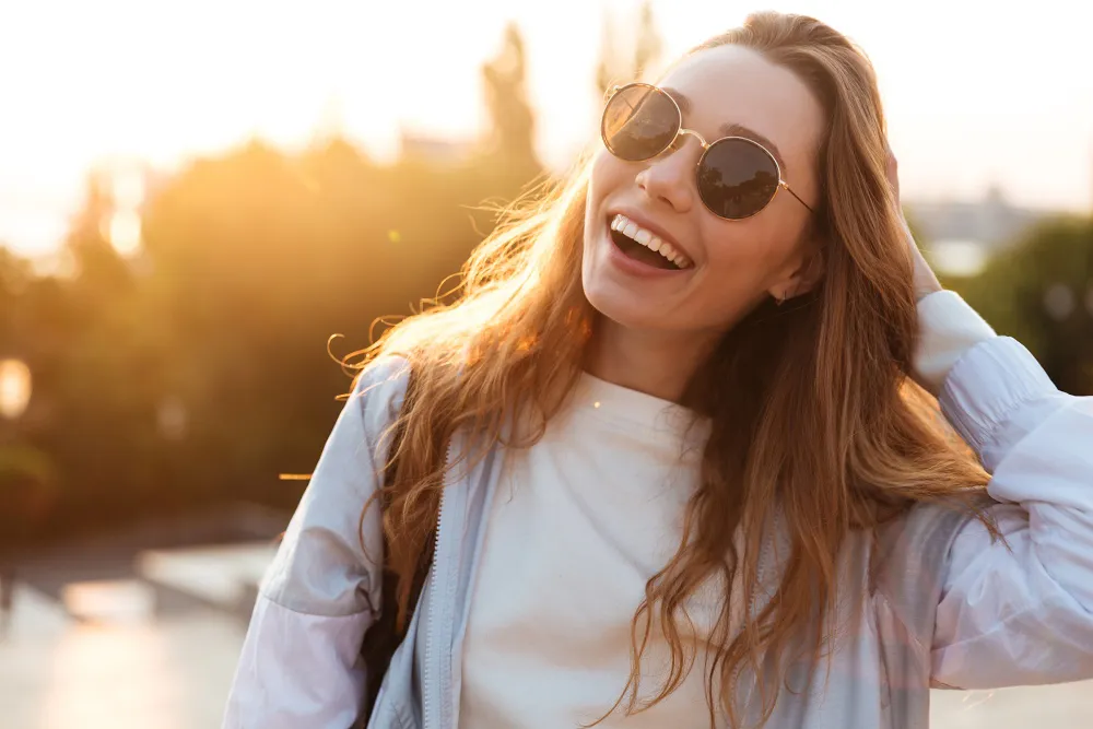 Vibrant young woman wearing sunglasses outside
